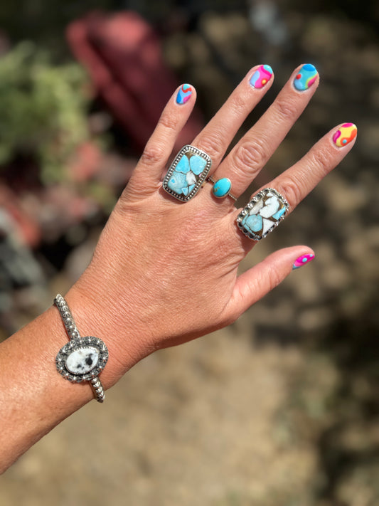 Kingman Ring (shown on middle finger)